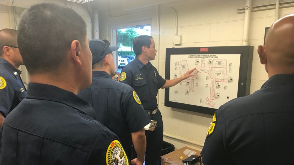 Fire inspectors reviewing a wall map